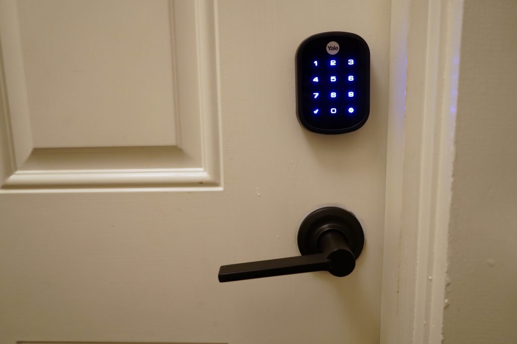 Smart-lock keypad mounted beside a front door.