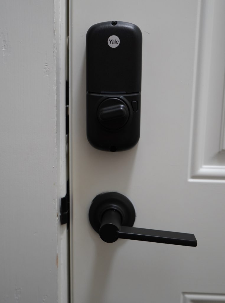 Exterior smart-lock hardware above the door handle.