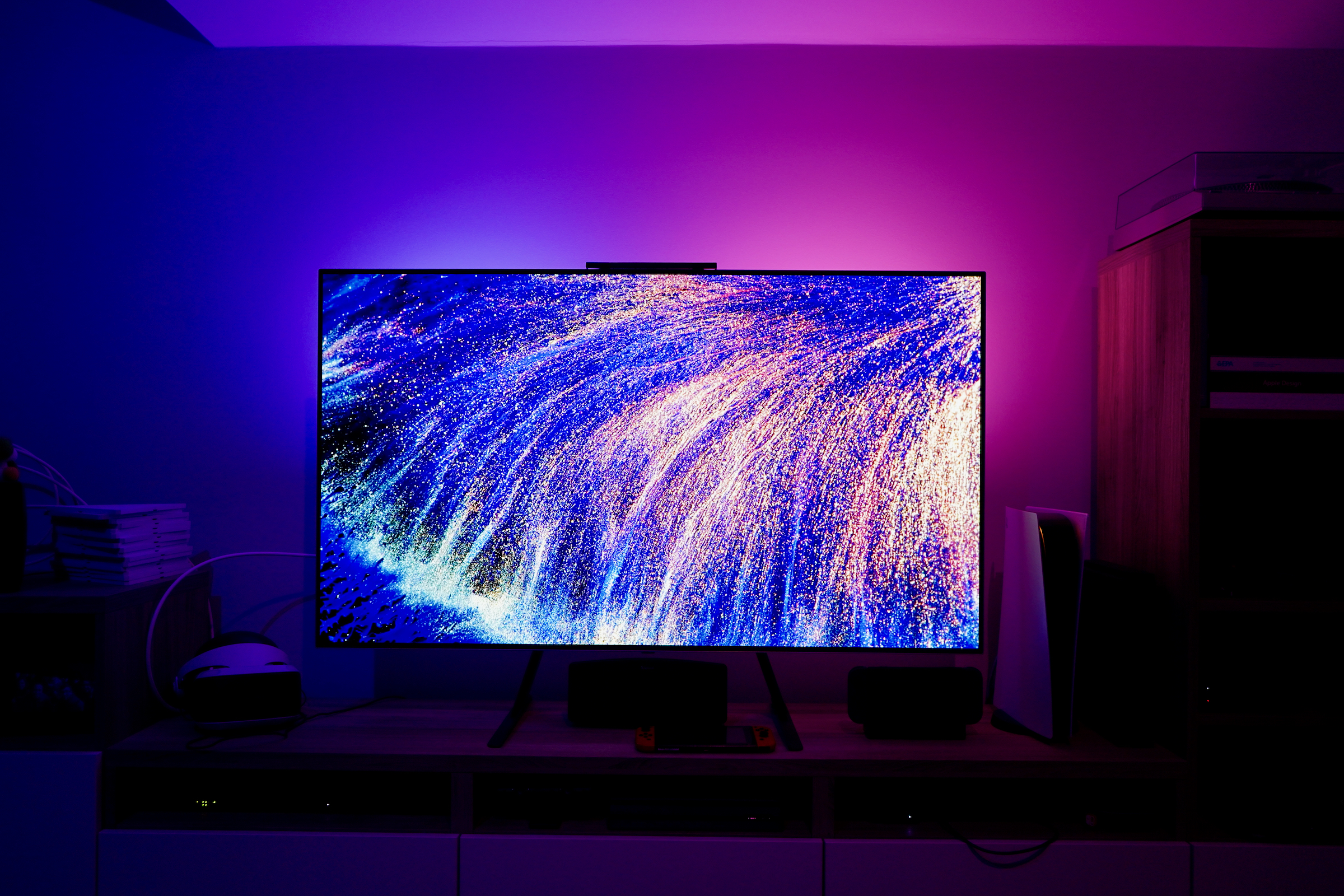 Television surrounded by colored ambient lighting.