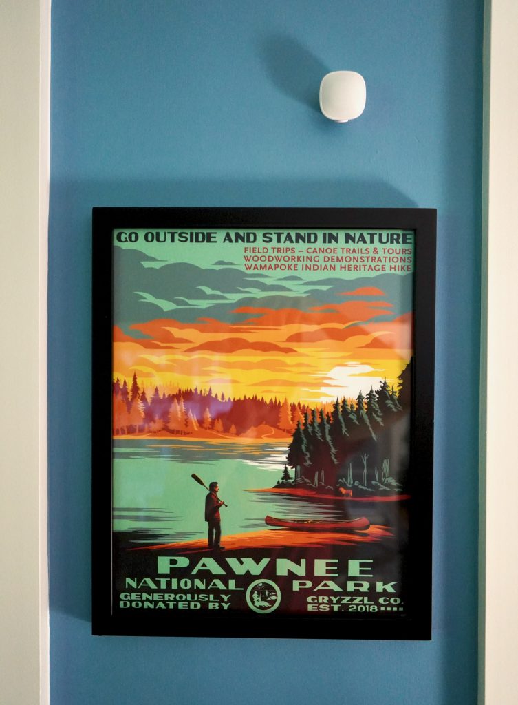Ecobee room sensor mounted above a framed poster.