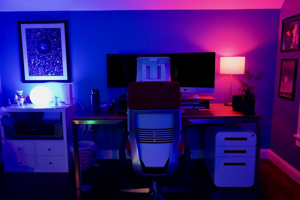Home office illuminated by blue and magenta Philips Hue lighting.