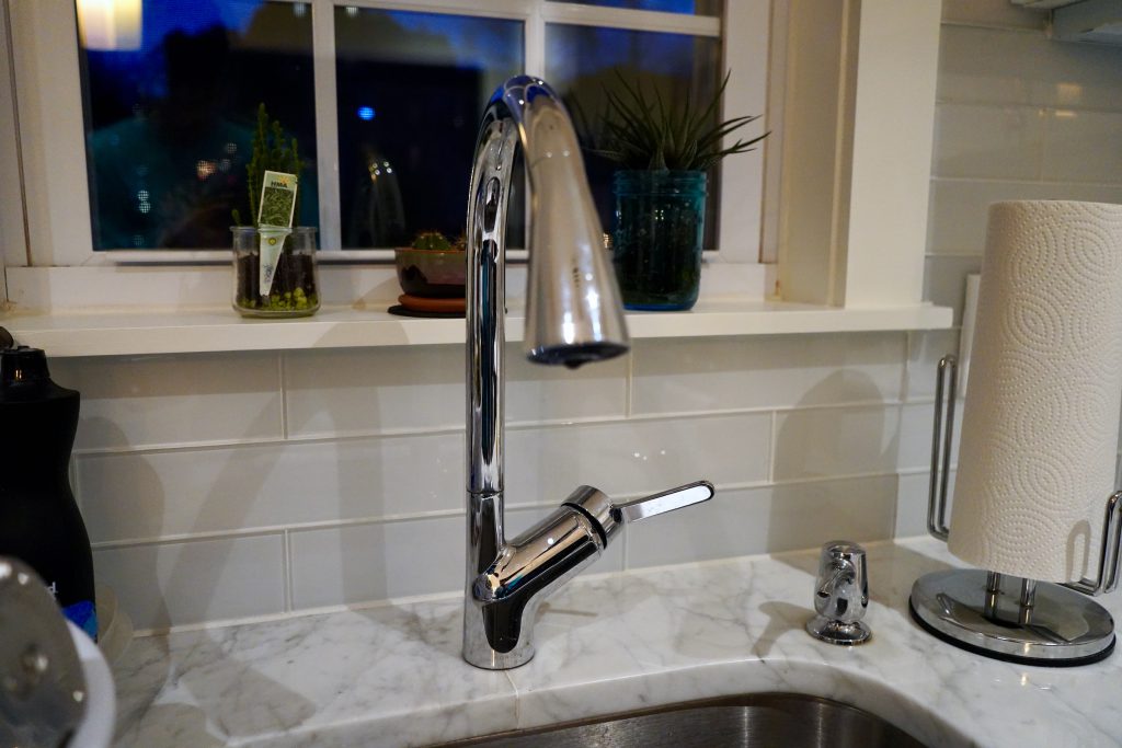 Kohler smart faucet installed over a kitchen sink.