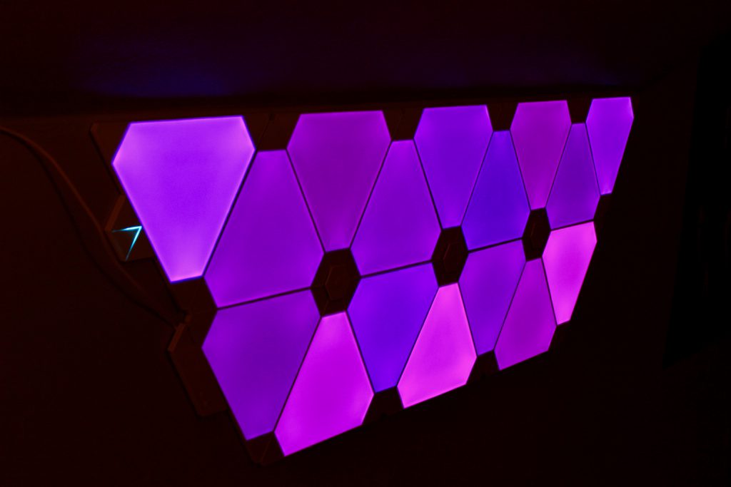 Geometric Nanoleaf wall panels glowing purple.