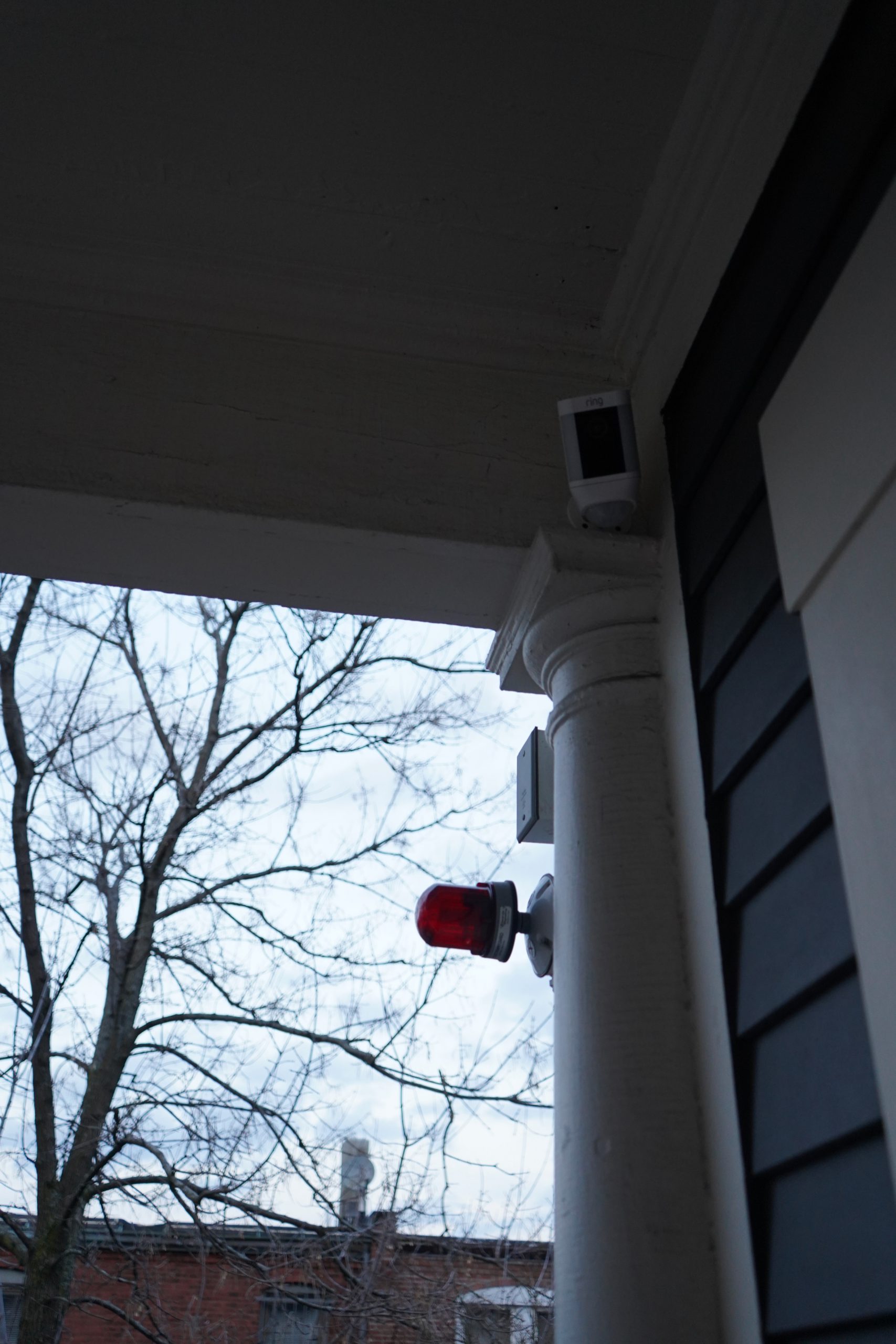 Outdoor Ring security camera mounted beside a window.